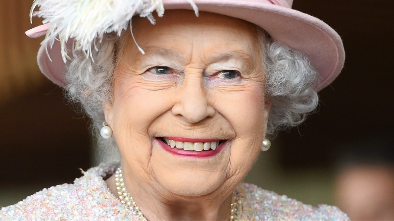 Queen Elizabeth II smiling with red lipstick