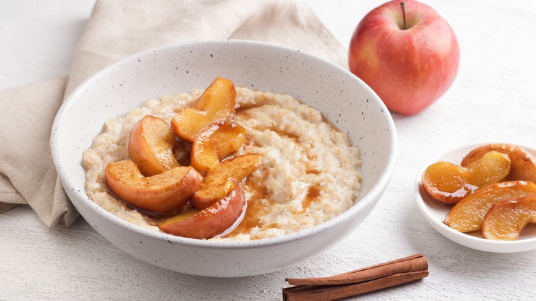 Bowl of oatmeal topped with apples