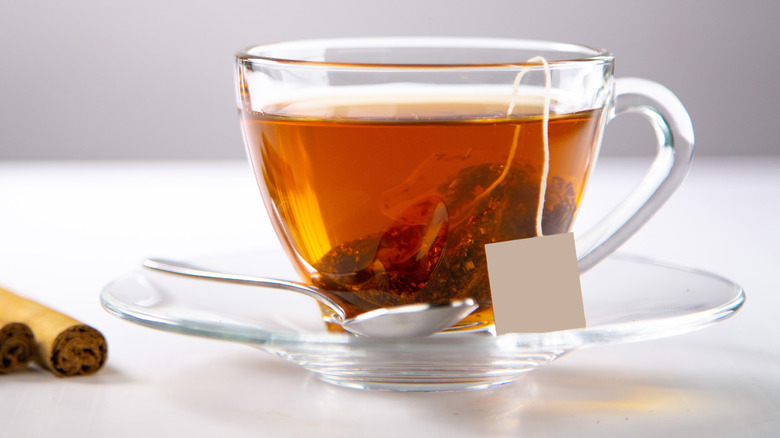Cup of cinnamon tea with cinnamon sticks
