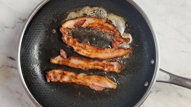 cooked bacon in a frying pan