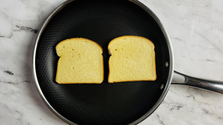 sliced white bread in a frying pan