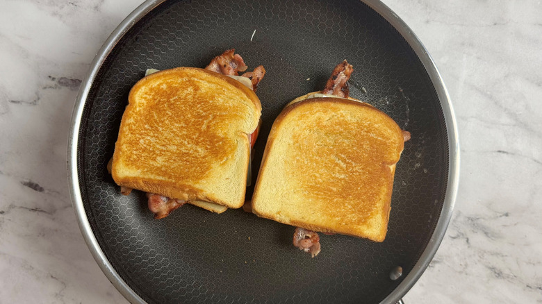 two toasted sandwiches in a frying pan