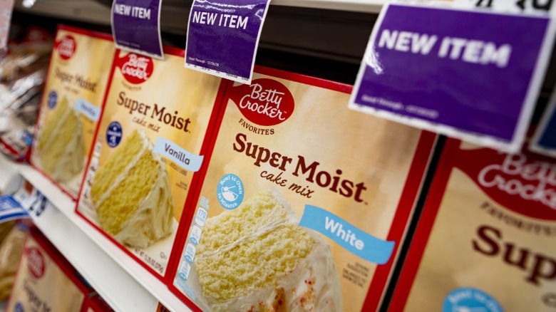 Boxes of Betty Crocker super moist white cake mix on a store shelf