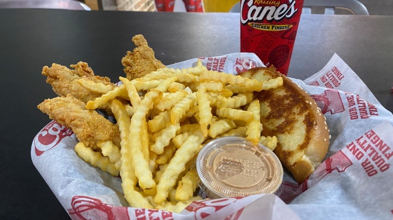 Chicken fingers, Texas toast, Cane's sauce, and fries in a tray from Raising Cane's
