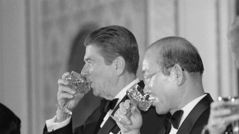Ronald Reagan sipping wine in a tuxedo