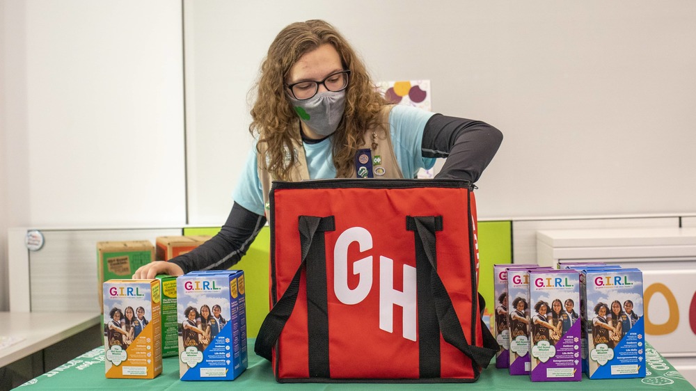 Filling Grubhub bag with Girl Scout cookies