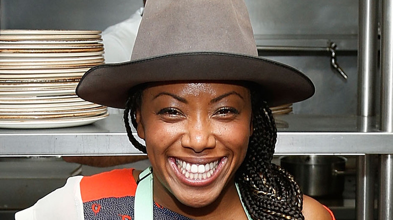 Nyesha Arrington smiles with hat