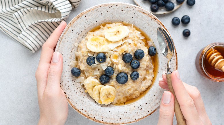bowl of oatmeal with bananas and blueberries