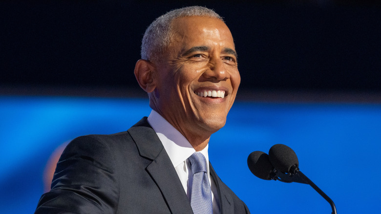 former president Barack Obama smiling at public event