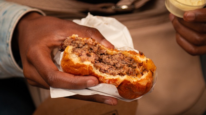 woman holding smashburger