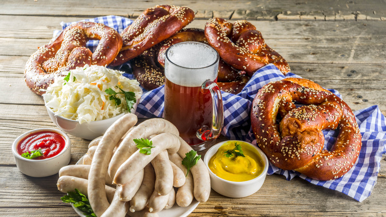 Sausages, pretzels, and beer on wooden surface