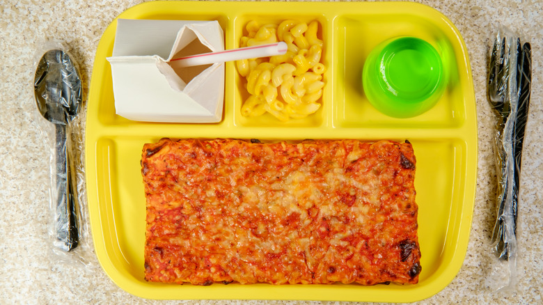 yellow cafeteria lunch tray with pizza and mac and cheese
