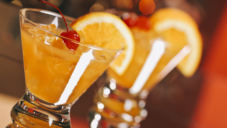 Harvey Wallbanger cocktails in glasses garnished with orange slices and maraschino cherries