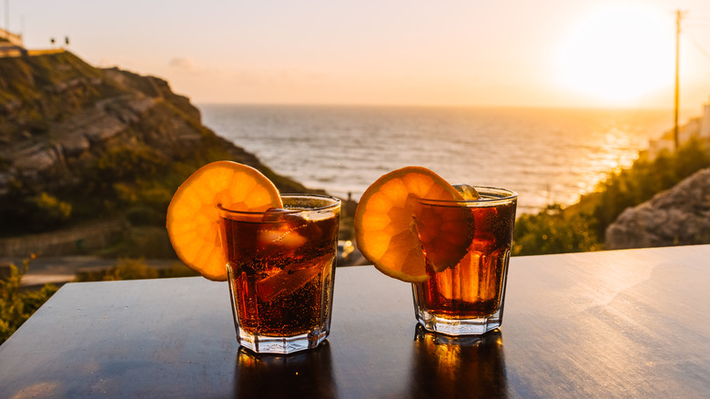 whiskey cocktails in front of sunset