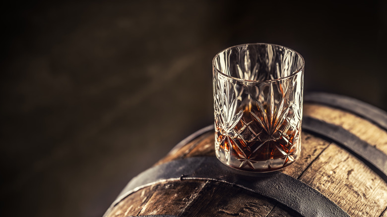 whiskey glass resting on keg