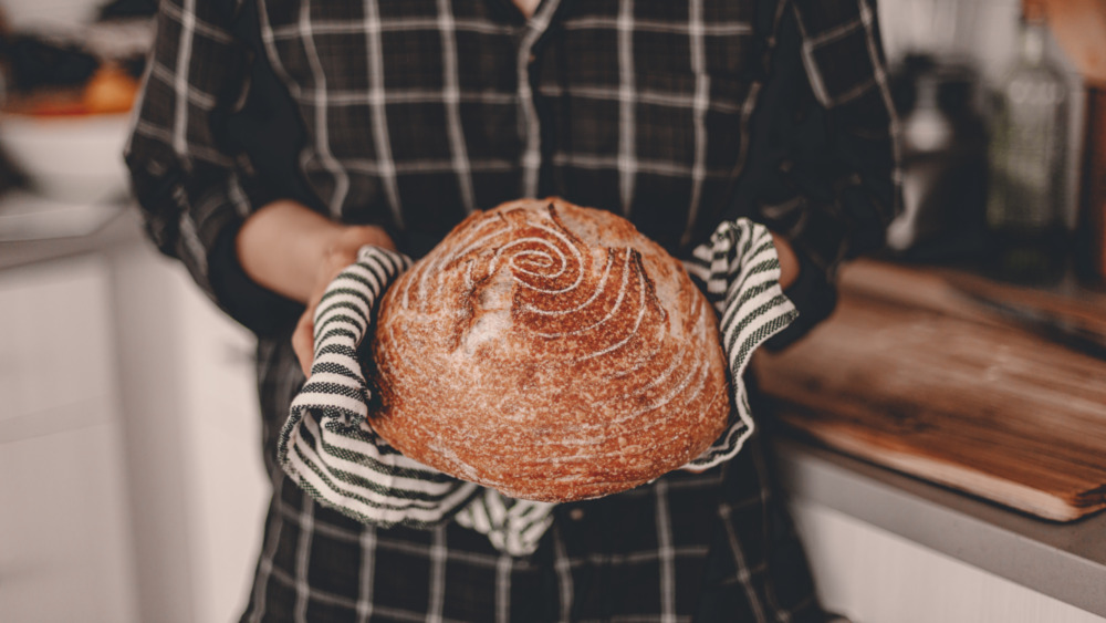 woman with freshly baked sourdough bread