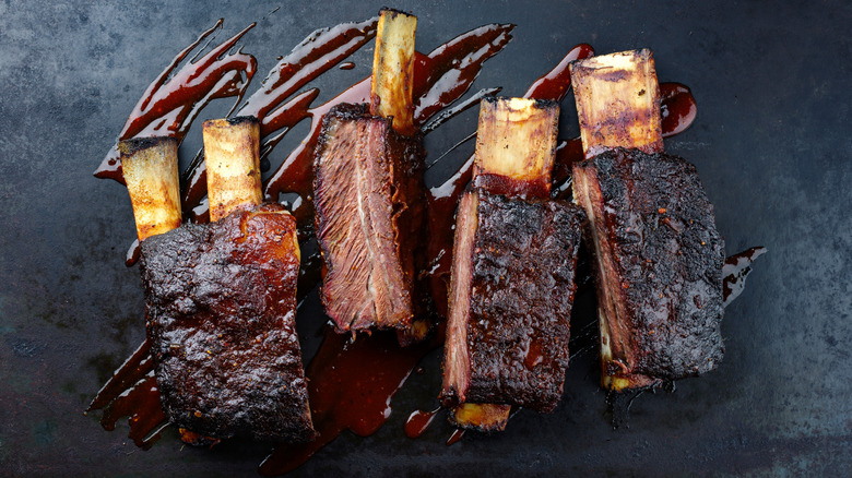 Grilled beef short ribs served on top of sauce