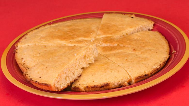plate of corn pone on red plate