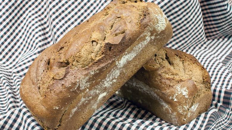 homemade loaves on black and white checkered fabric
