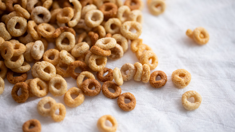 Cheerios scattered on white fabric