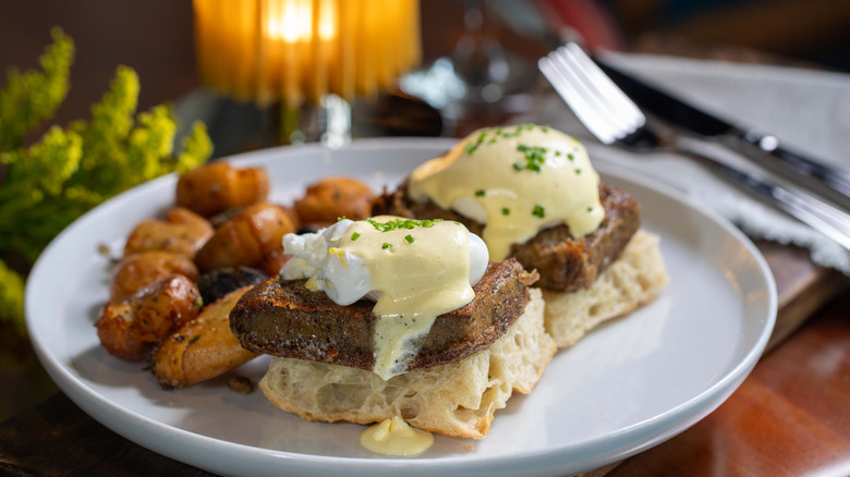 Eggs Benedict with scrapple with potatoes