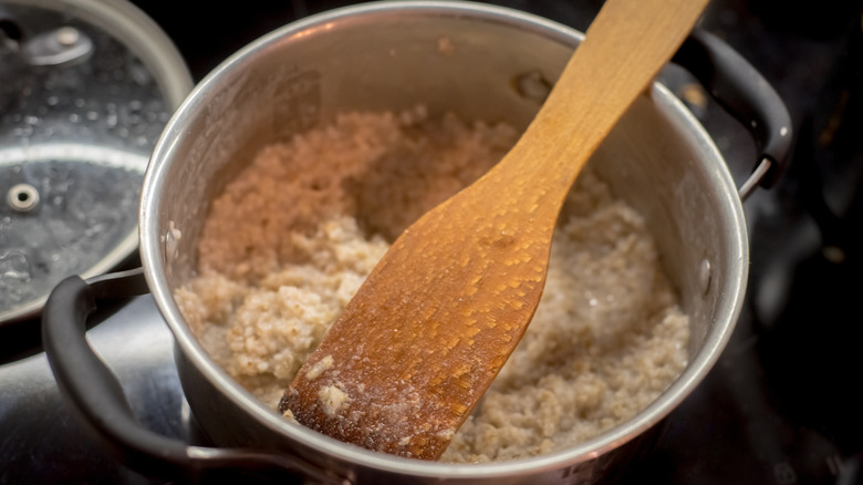 Wheat porridge in pot on stove
