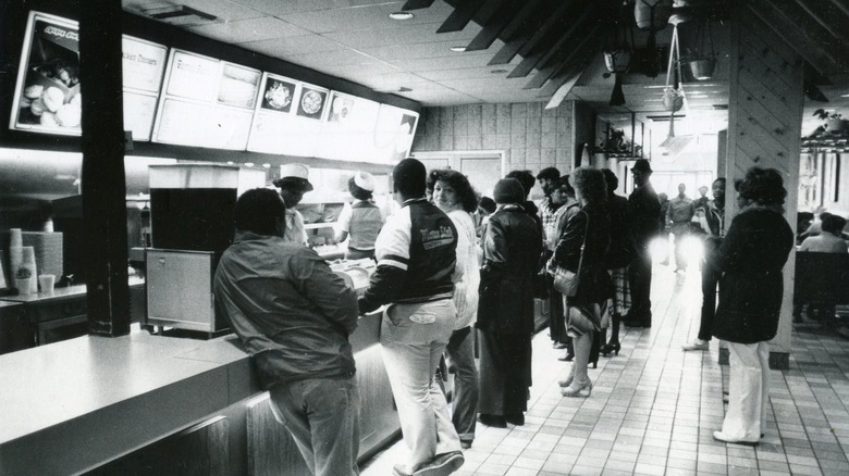 Customers at counter of Chicken George restaurant