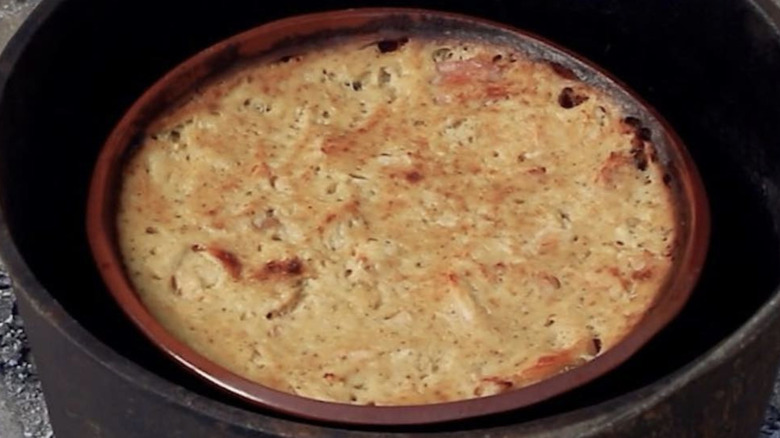 Chicken pudding cooking in an iron pot