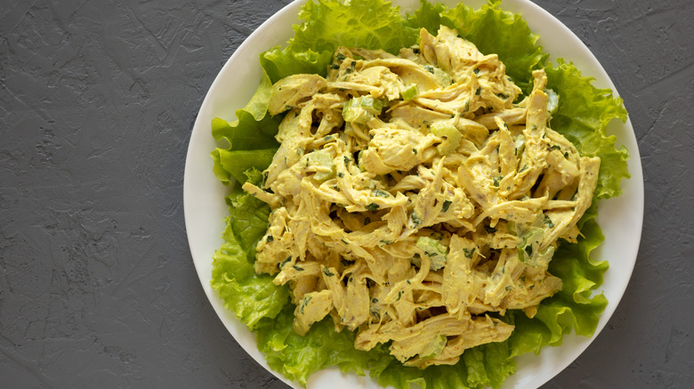 Plate of coronation chicken salad on bed of lettuce