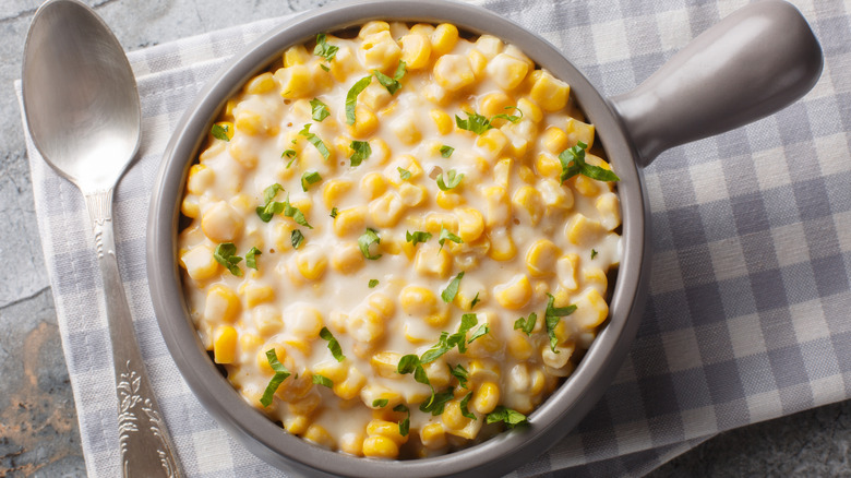 Bowl of cream corn with spoon