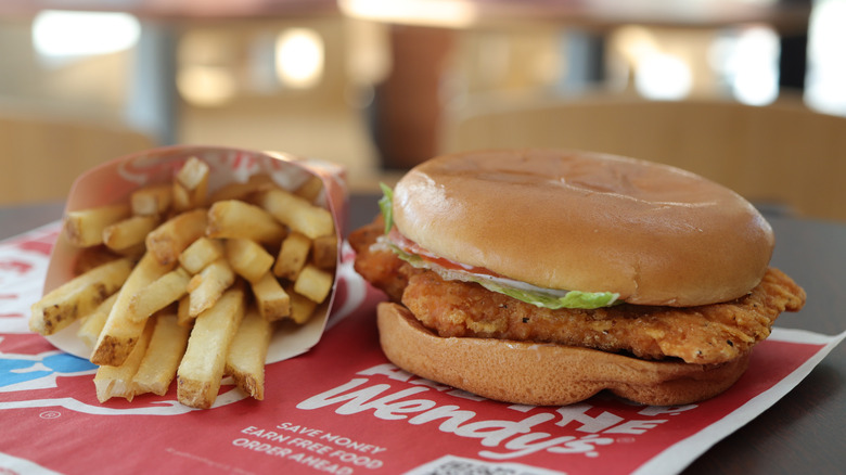 Spicy chicken sandwich on tray with fries at Wendy's restaurant