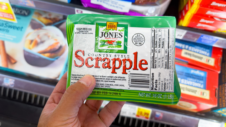 person holding package of scrapple inside grocery store