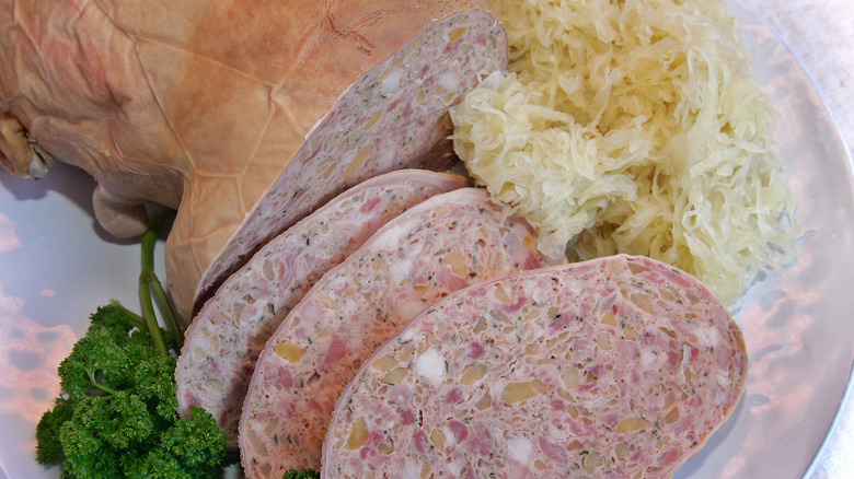 A platter of sliced saumagen served with sauerkraut