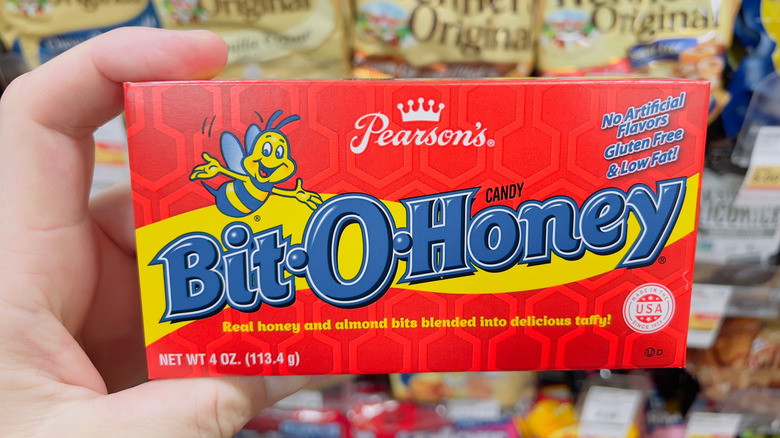 hand holding box of Bit-O-Honey candy