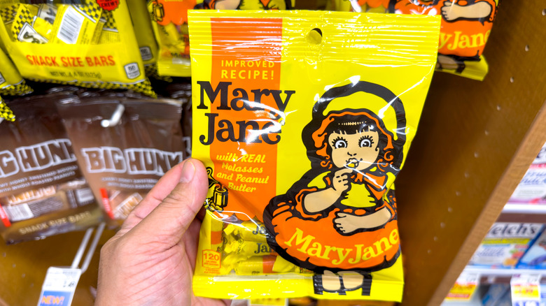 hand holding pack of Mary Jane candies