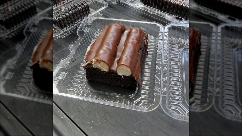 Slice of bumpy cake in plastic tub