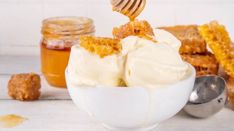 Scoops of frozen custard drizzled with honey in a bowl