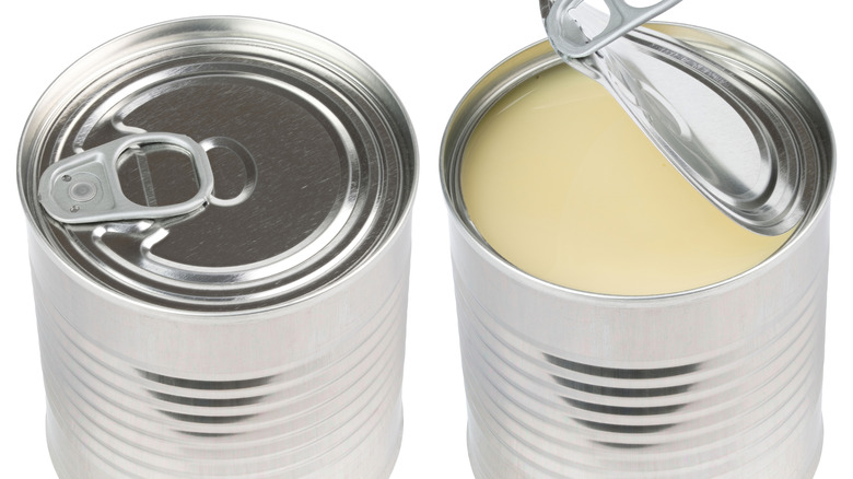 two cans of condensed milk, one closed and one with the lid pulled back