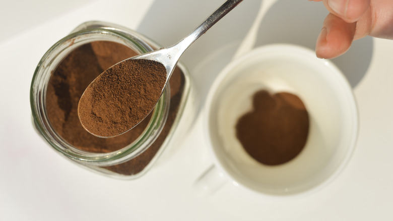 A spoon with instant coffee