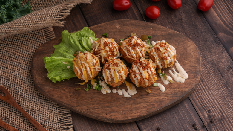 Duchess potatoes on wooden board