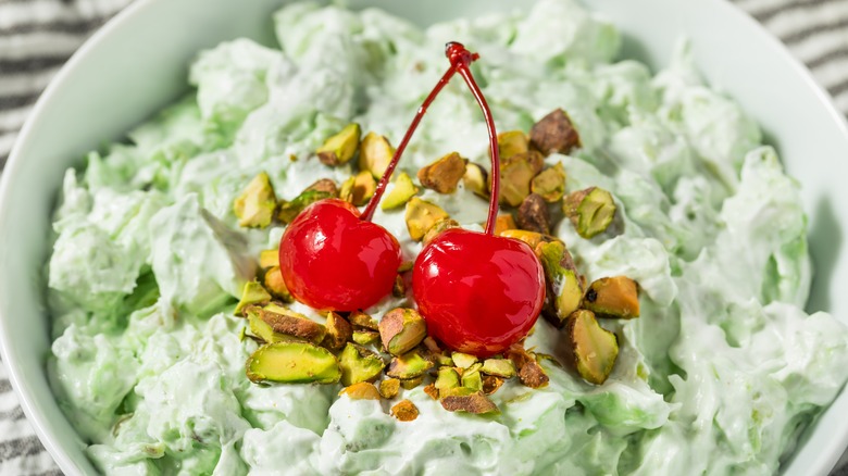 Watergate salad topped with cherries