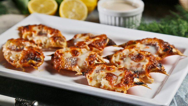 Platter of baked oysters topped with cheese