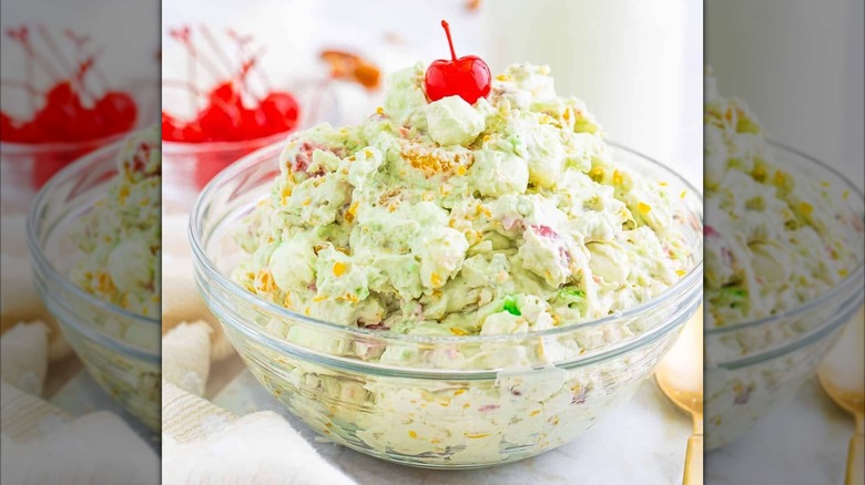 A bowl of Watergate salad with a cherry on top