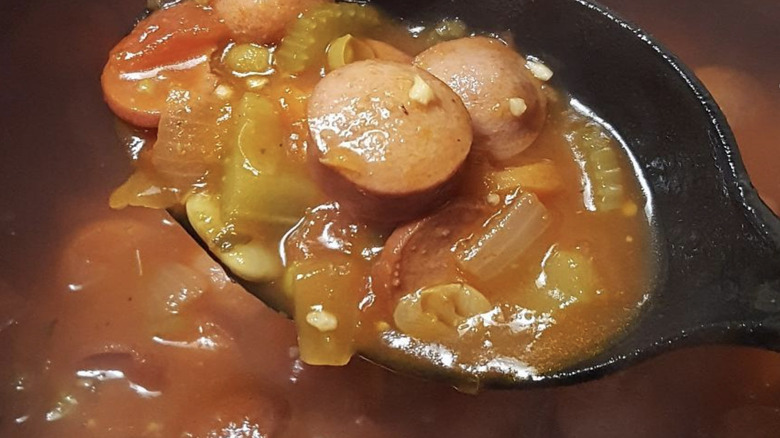 Close-up of hot dog soup on spoon