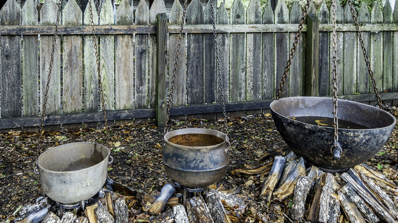 Cauldrons suspended by chains on a former plantation