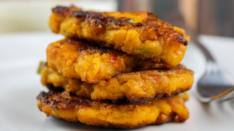 sweet potato pancakes stacked on plate