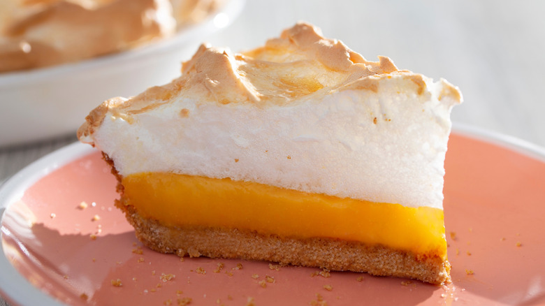 Slice of orange meringue pie on plate