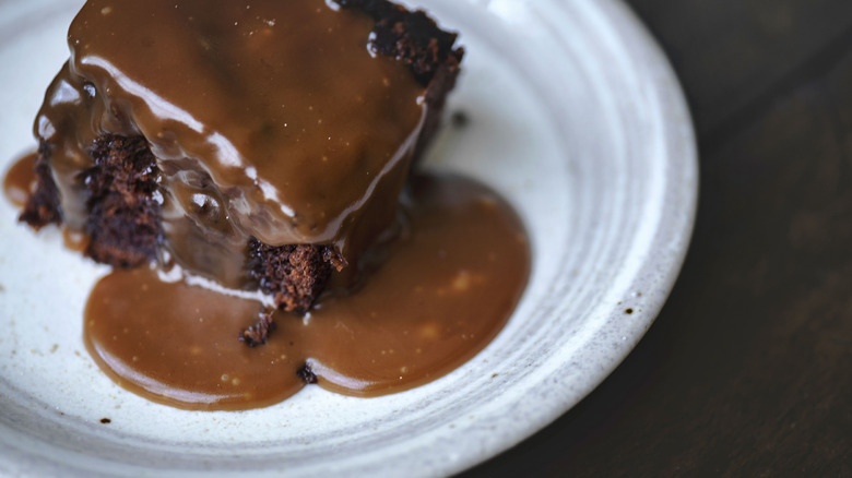 Dark cake with sauce on top