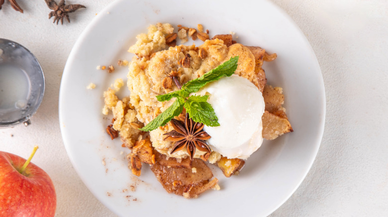 Apple cobbler or apple slump in dish with ice cream