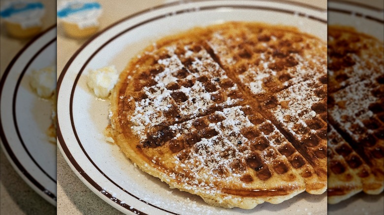 Waffle with powdered sugar and syrup
